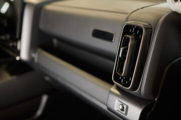 Closeup of car dashboard air vents near gear shift