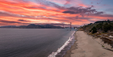 Golden Gate Bridge with Sandy Beach and Rugged Coastline in View