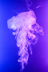 Twisted plume of smoke. The movement of smoke on a colored background. Abstract smoke lines