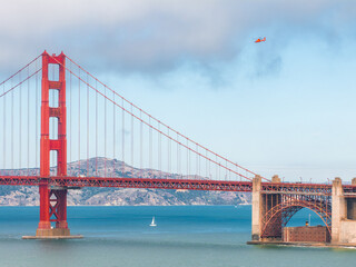 Golden Gate Bridge with Sailboat and Helicopter in San Francisco Bay