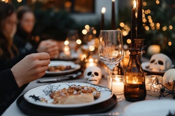 A creepy Halloween dining setup with black candles, skulls, and spider web motifs, creating a chilling yet stylish atmosphere for an unforgettable feast.