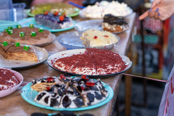 Multiple flavours and types of Crepe Layer Cake (Pancake Cake) with Strawberry, Chocolate, Cookie, Red Velvet, Grape flavors for sale at Jogokariyan Ramadan Night Market, Yogyakarta, Indonesia.