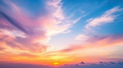 Obraz premium A vibrant sunrise paints the sky with hues of pink, orange, yellow, and blue, as clouds dance across the canvas.