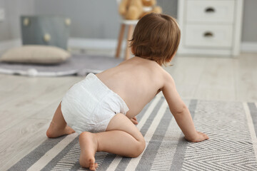 Cute little child in diaper at home