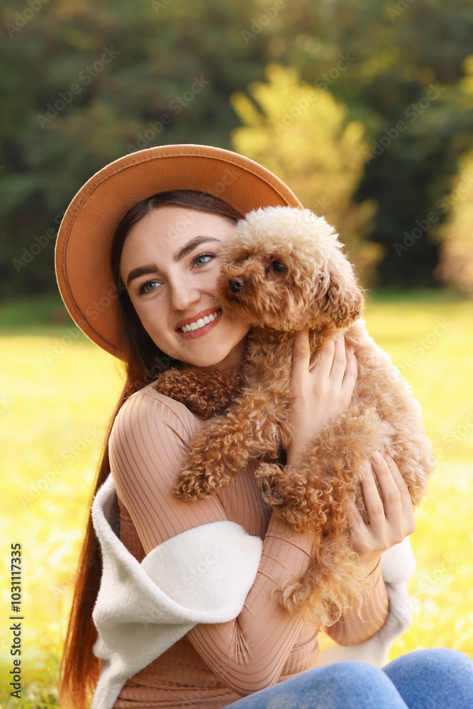 Poster Smiling woman with cute dog in autumn park