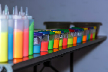 bottles filled with multicolored fluorescent paints for coloring pictures. children's bright colors.