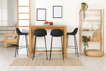 Bar stools near wooden table in room