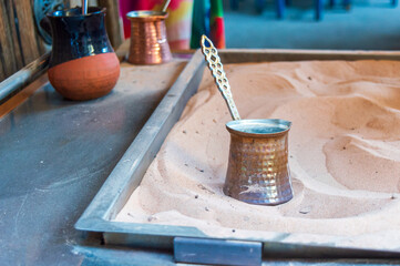 Making Brewing traditional authentic Turkish coffee on hot sand.