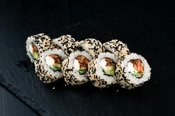 Sushi rolls with tuna, salmon, cream cheese, avocado, cucumber and sesame seeds.
