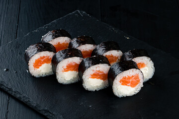 Traditional Japanese cuisine set of sushi rolls with salmon, cream cheese, rice and nori.