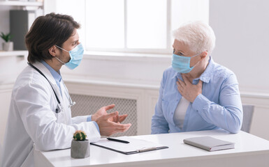 Concept of professional consultation in therapy system. Doctor consulting senior woman with cough, in office