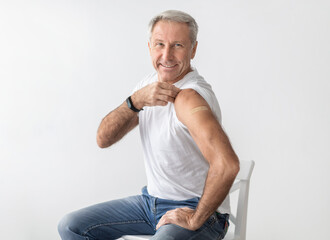Covid-19 Vaccination Concept. Vaccinated Senior Man Showing Arm After Vaccine Shot For Antiviral...