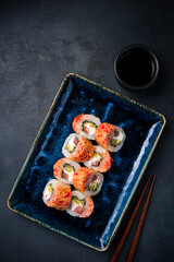 Set of sushi rolls with tuna, cream cheese, mango and flying fish caviar.