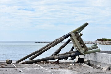 Fototapeta premium boat dock section washed ashore from storm hurricane destruction