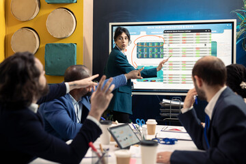 Team members assembling in a meeting to debate latest events and updates on organization situation. Manager and employees receive instruction to build an international corporation.