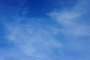 A Serene Expanse of Bright Blue Sky Dotted With Wispy Clouds Above a Tranquil Landscape During Midday