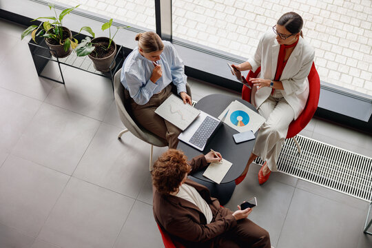 Three skilled professionals are engaged in a collaborative and insightful discussion using modern technology tools