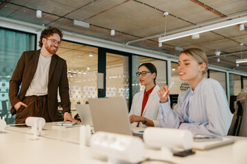 A diverse team collaborates in a modern office, sharing ideas and brainstorming to achieve goals...
