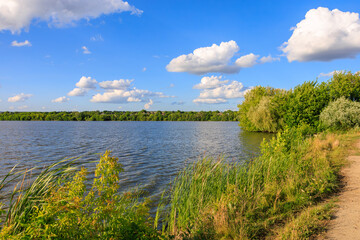 A beautiful lake with a cloudy sky in the background