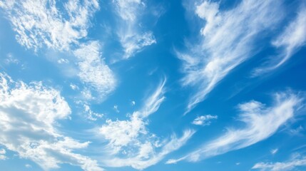 clear blue sky adorned with wispy white clouds, creating a serene and tranquil atmosphere.