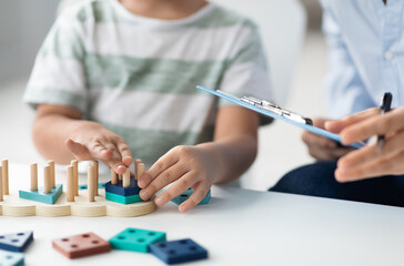 Kids development classes. Close up shot of unrecognizable little boy playing logical educational...