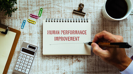 There is notebook with the word Human Performance Improvement. It is as an eye-catching image.