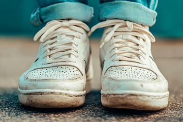 Muddy sneakers after outdoor run on wet road