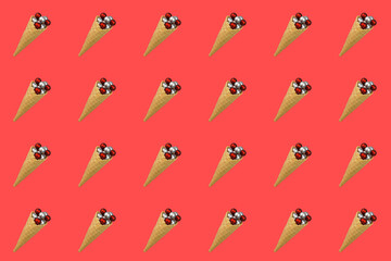 Obraz premium Waffle cone for ice cream with Christmas balls on a red background. Seamless background pattern for wrapping paper, printing, wallpaper. Preparing for Christmas and New Year.