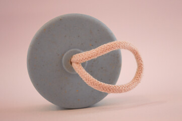 water bottle caps with strings serving as handles, white background