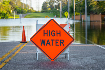Flooded road. High water road sign. Road or highway closed. Florida hurricane and tropical storm...