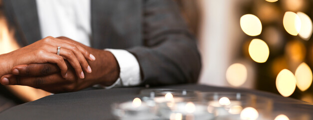 Cropped of black man holding woman hand with ring on, got engaged