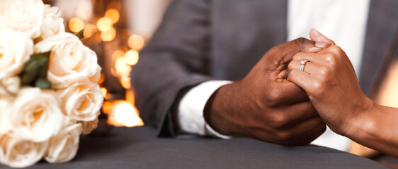 Engagement concept. Cropped image of black couple in restaurant, woman said yes on marriage proposing