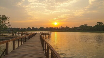 Fototapeta premium Sunset Over Tranquil Water with Wooden Walkway