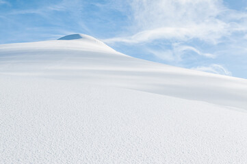 Majestic snow covered mountain peak against clear blue sky, copy space for text or design - Winter natural landscape. Snowdrift sunny day