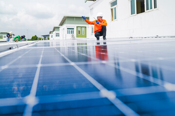 engineer man inspects construction of solar cell panel or photovoltaic cell by electronic device....