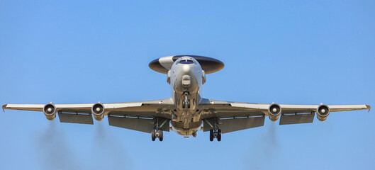 The plane against the blue sky. Landing plane front view
