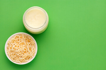 spoon and bowl with oil and grated coconut - Cocos nucifera.