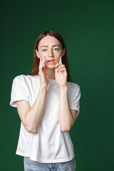 Studio portrait of a girl model isolated on green background