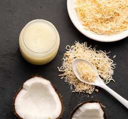 spoon and bowl with oil and grated coconut - Cocos nucifera.