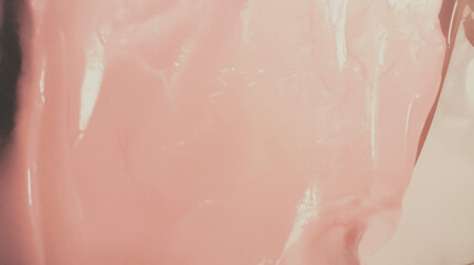Fototapeta premium a close-up, top-down view of milky pink, smooth and glossy paint, filling the entire frame with a focus on the perfectly flat, silky texture of the surface