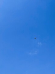 An airplane flying high above the blue sky