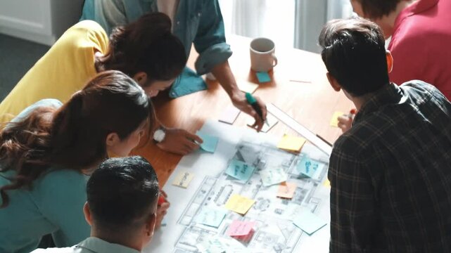Top view of business team working together and putting fist together at meeting room. Aerial view of skilled architect engineer making circle from fist. Represented love, unity, teamwork. Symposium.