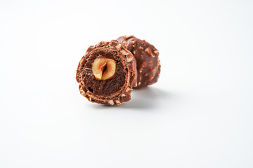 Sweet chocolate balls is made. Chocolate candy in gold wrapper on white background