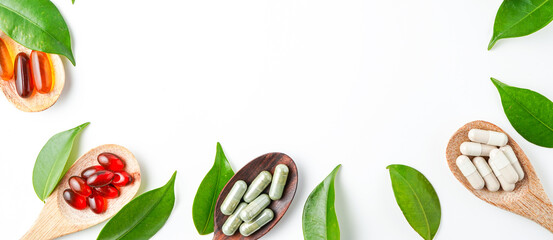 Top view Variety of vitamin and mineral pills in wooden spoon, Dietary supplement healthcare