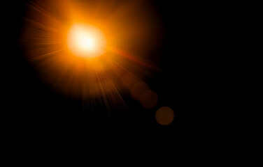 Abstract image featuring a bright light source with rays of light extending out from it. The background is dark and blurry.
