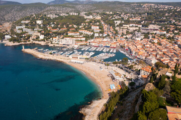 Fototapeta premium Scenic drone view of coastal small French town of Cassis overlooking port with moored yachts on sunny day .