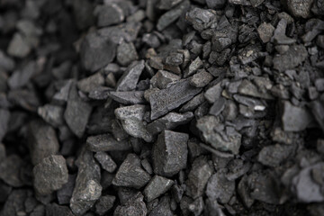 Close up of a pile of coal on a construction site, selective focus