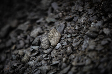 Close up of a pile of coal on a construction site, selective focus