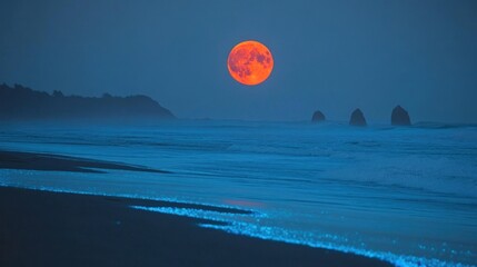 A large, orange moon rises over the ocean with bioluminescent waves glowing at the shoreline.