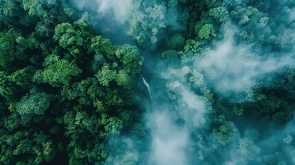 Fototapeta premium Lush Green Forest with Waterfall and Mist Above